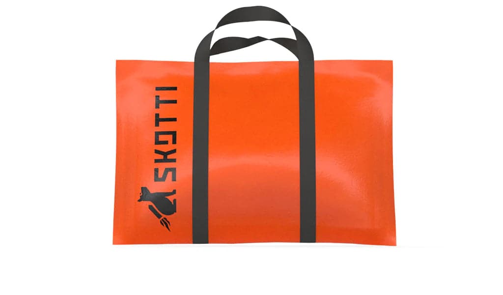 portable SKOTTI gas grill in orange tarp bag